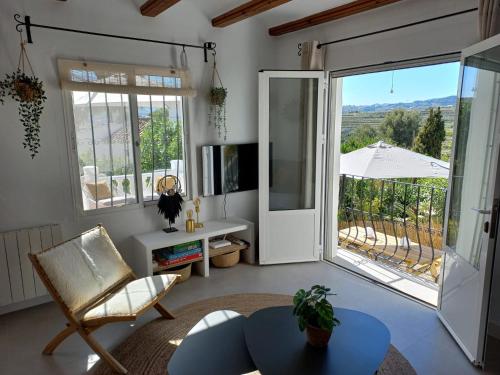 a living room with a table and a large window at Villa Estrella de Mar in Moraira