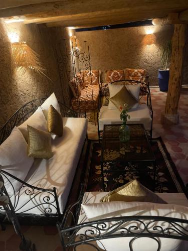 a living room with two beds and a table at La Maison Berber Shams in Marrakech