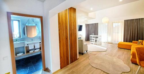 a living room with a yellow couch and a living room at Vila Simonte Poiana Brasov in Poiana Brasov