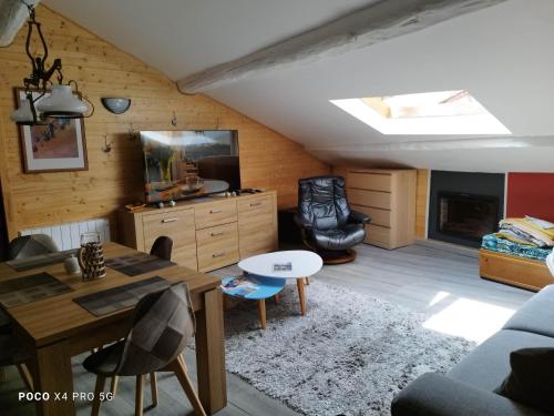 a living room with a couch and a table at loftvesubie Studio in Saint-Martin-Vésubie