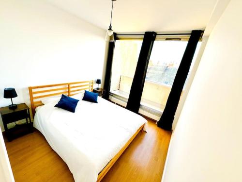 une chambre avec un lit et une grande fenêtre dans l'établissement Casa Luciano, à Dunkerque