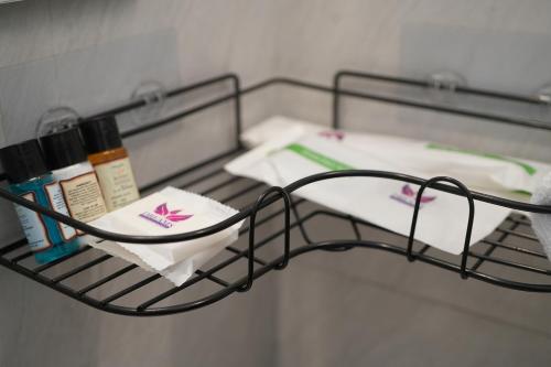 a shelf with products on it in a bathroom at Livora Residency in Chennai