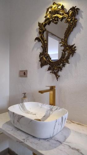 a bathroom with a large marble sink and a mirror at Alegria rustica 2 Rustic happiness in Envendos