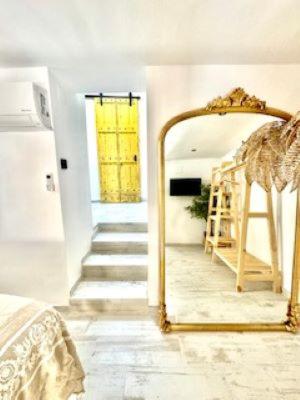 a large mirror in a room with a staircase at La Esquina 1B in Denia