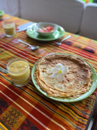 a table with a plate of food with a flower on it at Rancho Burica in Pavones