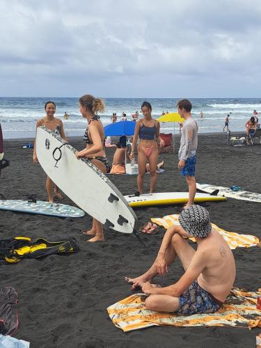 a group of people on the beach with surfboards at Casanaga in Almáciga