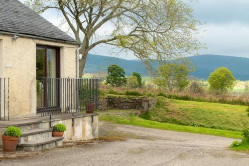 a house with a porch and a driveway at Foulis Cottage, Foulis Estate, Highland Scotland in Ardullie
