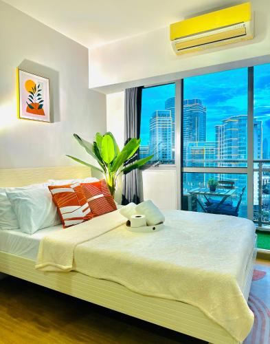 a bedroom with a large bed with a large window at 1BR Acqua Residences ,Mandaluyong just 3-5 mins to Makati district in Manila