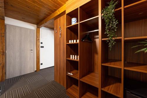 a room with wooden shelves and a hallway at Penzion No 212 in Napajedla