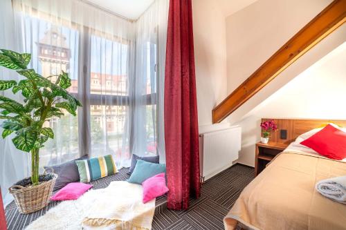 a bedroom with a bed and a large window at Penzion No 212 in Napajedla