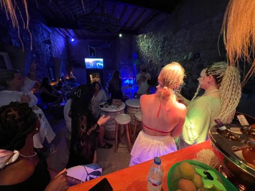 a group of people sitting in a room at a party at The Old Mill Hotel Lapta in Kérynia