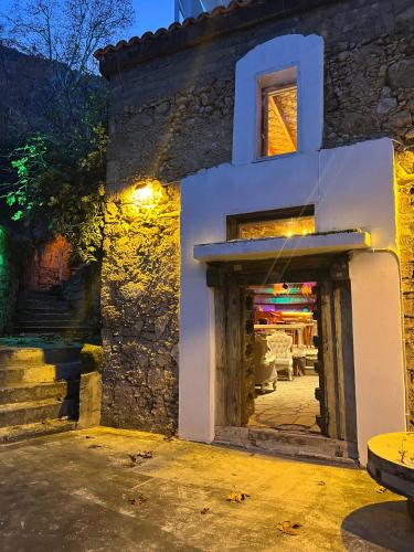 a white building with a doorway and a table at The Old Mill Hotel Lapta in Kérynia