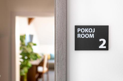 a sign on a door with the words kojo room at Penzion No 212 in Napajedla