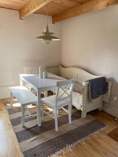 a dining room with a table and two chairs at Ferienwohnung auf dem Bauernhof in Mariannelund