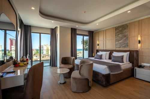 A bed or beds in a room at Awen Lara Hotel