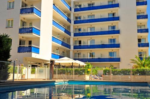a hotel with a swimming pool in front of a building at Appart'hôtel Goélia Sun City in Montpellier