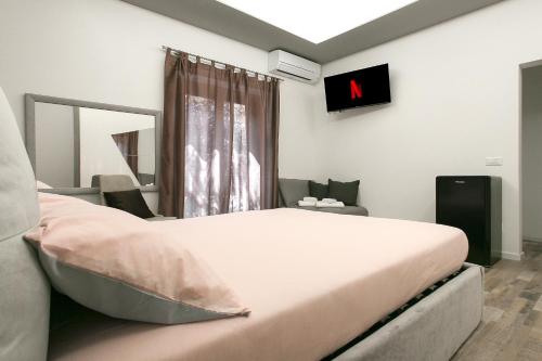 a bedroom with a large bed and a tv on the wall at Leyla's House in Gorle