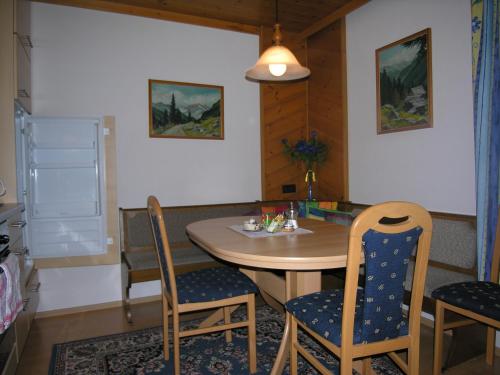 a dining room with a table and chairs at Haus Gutwenger in Sankt Jakob in Defereggen