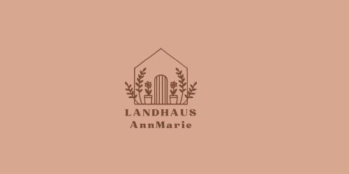 a logo for a landscaping company with a building at LANDHAUS AnnMarie in Limbach im Burgenland