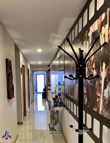 a hallway with a large wall of pictures on the wall at Iris House AL Azores in Ponta Delgada