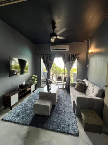 a living room with a couch and a table at Bayu Beach Resort Port Dickson Santai PD Homestay 2 Bedroom Apartment in Port Dickson