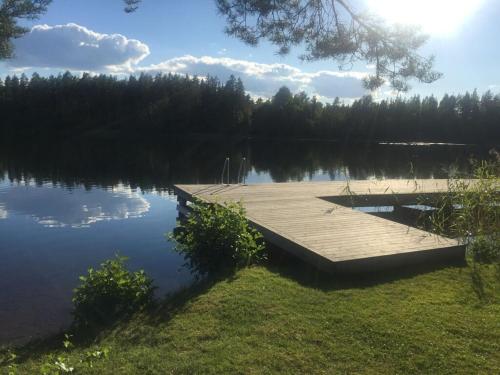 a dock in the middle of a lake at Modern apartment in Vimmerby in Vimmerby