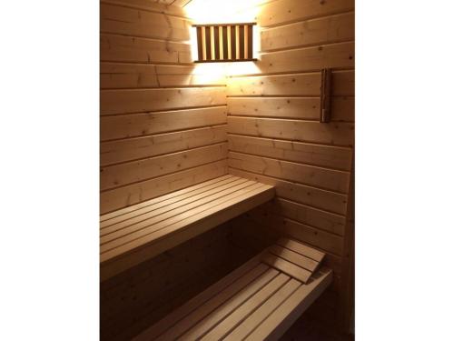 a wooden sauna with a light on top of it at Modern apartment in Vimmerby in Vimmerby
