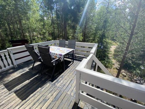 a wooden deck with a table and chairs on it at Modern apartment in Vimmerby in Vimmerby