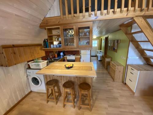 a kitchen with a counter and stools in a house at Modern apartment in Vimmerby in Vimmerby