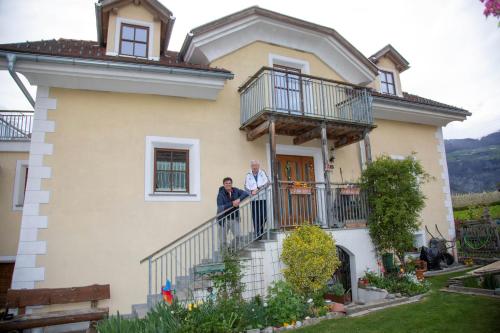 two people standing on a balcony of a house at Mulino Glurns in Glorenza