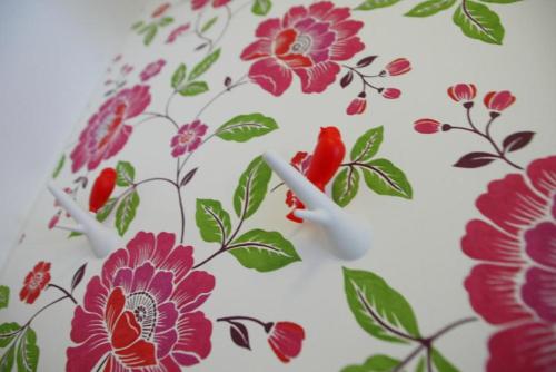 a wallpaper with red flowers on a white background at Riverside stay at Hotel - Ängelholm in Ängelholm