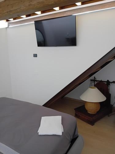a room with a bed and a tv and a lamp at HOUSE Sant'Angelo in Acquapendente