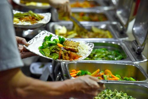 a person is holding a plate of food at Mara Chui Eco-Resort in Sekenani