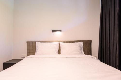 a bedroom with a large bed with white sheets at Rokah Luxury Villa at Ramat HaHayal in Tel Aviv