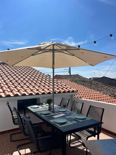 a table with an umbrella on a patio at Casa Alentejana - Casa Olival in Nisa