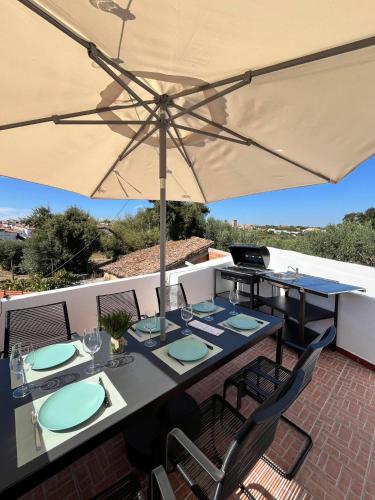 a table with an umbrella on a patio at Casa Alentejana - Casa Olival in Nisa