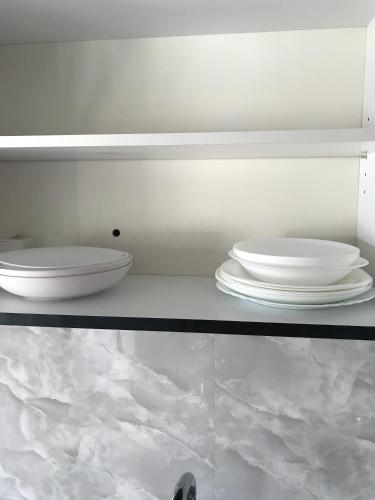 two images of a shelf with plates on it at CENTRAL ROOMS WITH GREAT VIEW shared bathroom no parking in Skopje
