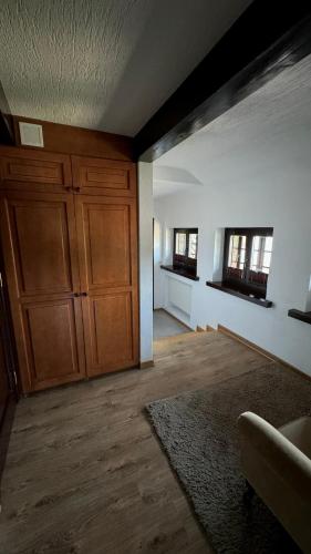 an empty living room with wooden cabinets and windows at Dom Pracy Twórczej Stowarzyszenia Filmowców Polskich w Kazimierzu Dolnym in Kazimierz Dolny