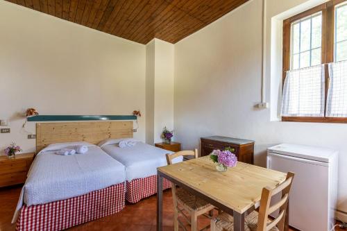 a bedroom with a bed and a wooden table at Cascina Gaggioli in Milan