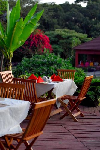 a table and chairs on a wooden deck at Mara Chui Eco-Resort in Sekenani