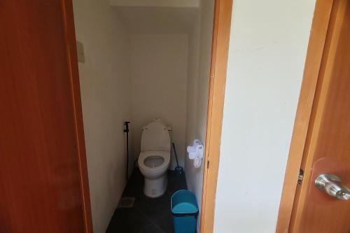 a bathroom with a toilet in a small room at Intoy's Place Panglao near Beach in Panglao