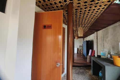 a wooden door in a room with a kitchen at Intoy's Place Panglao near Beach in Panglao