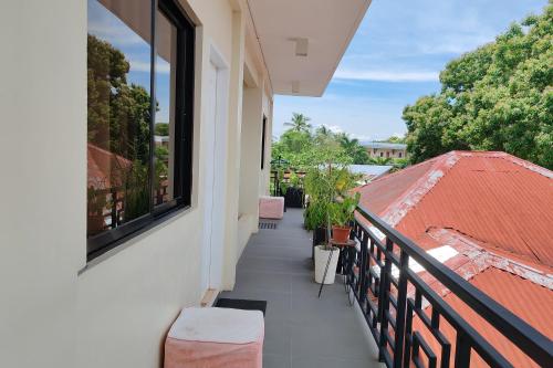a balcony with two chairs and a window at Intoy's Place Panglao near Beach in Panglao