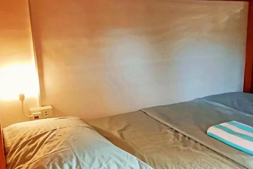 a bed in a room with a light on at Intoy's Place Panglao near Beach in Panglao