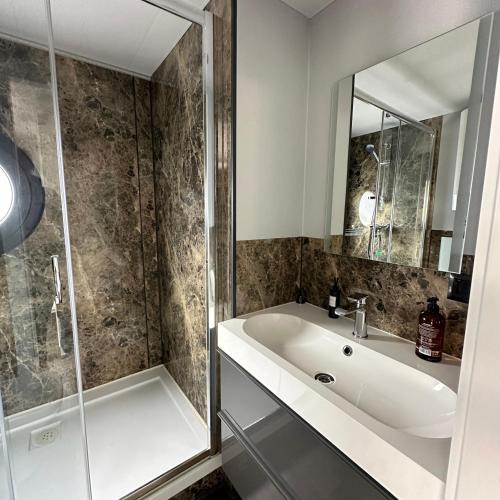 a bathroom with a sink and a shower at La Mare Resort in Gothenburg