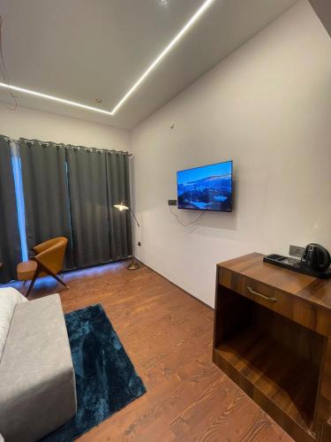 a living room with a flat screen tv on the wall at Royal Willow Bir Billing in Chauntrā