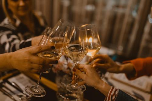 a group of people holding up wine glasses at Hotel President in Čapljina