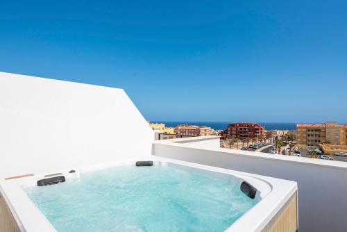 a hot tub on the balcony of a building at MEDANO4YOU Westside Penthouse in El Médano