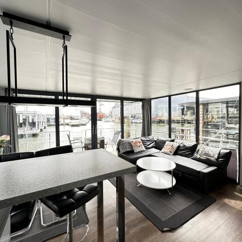 a living room with a couch and a table at La Mare Resort in Gothenburg