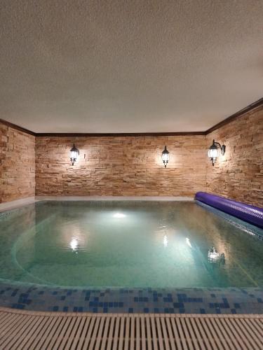 a large swimming pool in a building with lights at The Castle - Your unique way of retreat in Borovets